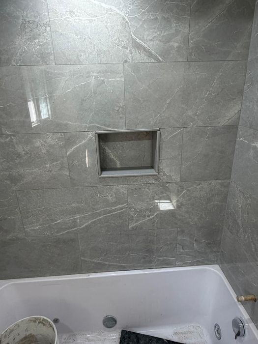 Grey marble-look tile with built-in shower niche