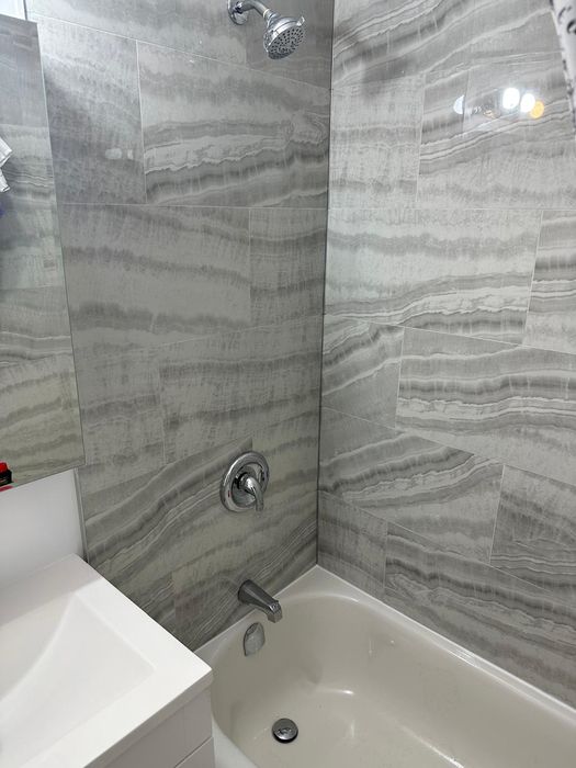 Grey onyx-look tile tub surround, fixtures and vanity
