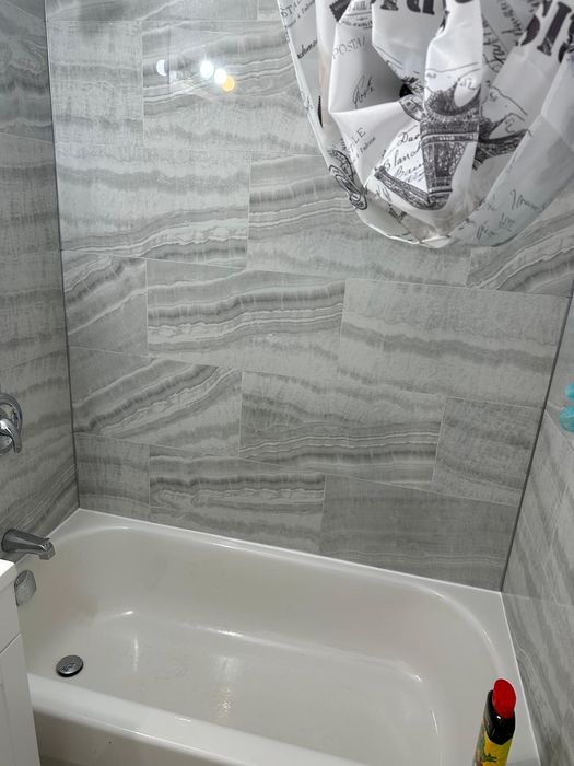 Onyx-look porcelain tile installed around an existing tub