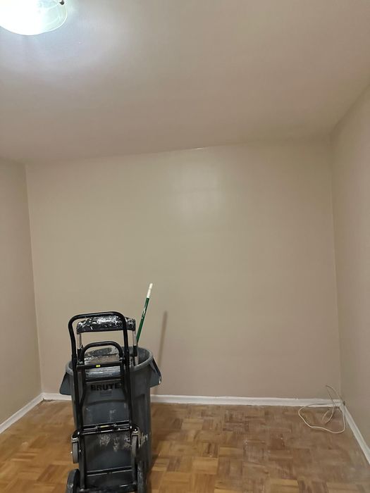 Room repaint with crisp baseboards over parquet